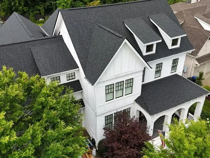 Aerial view of a new architectural shingle roof on a white farmhouse-style estate in Williamson County, TN