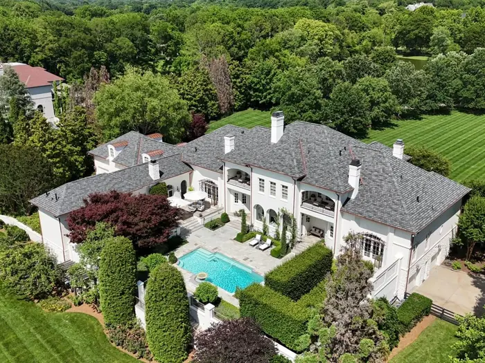 Drone photo of a large Franklin TN estate with a new roof, pool and manicured grounds