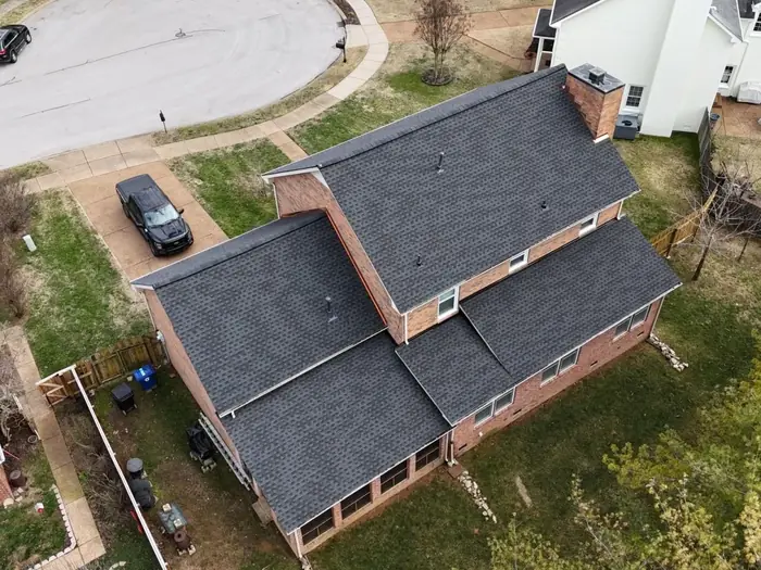 Brick home with a completed architectural shingle roof replacement in Nashville, TN