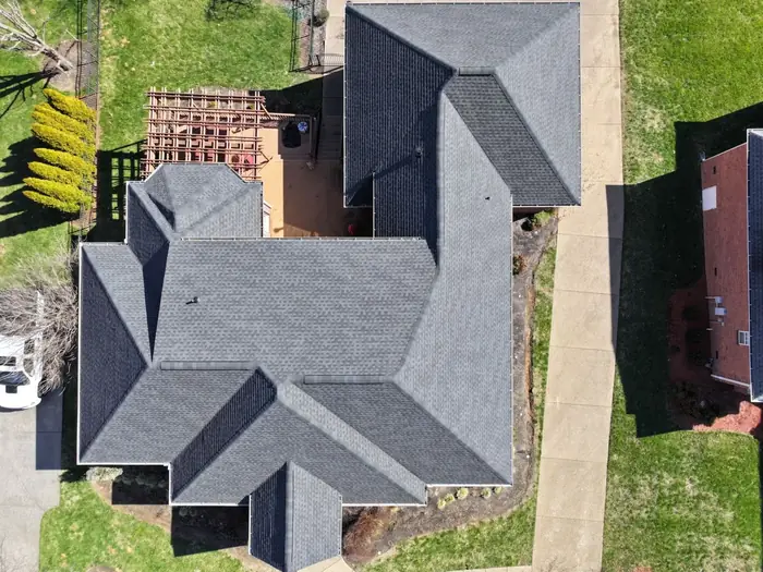 Overhead drone view of a complex multi-plane shingle roof replacement