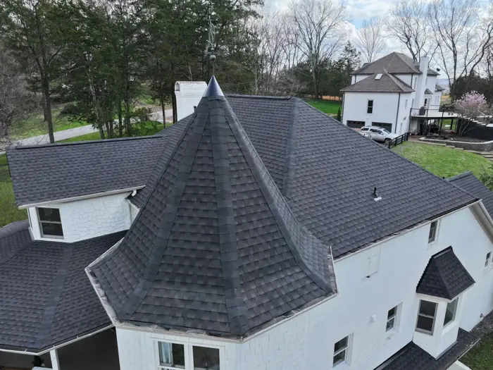 Close aerial of a turret roof finished in architectural shingle by Three Stone