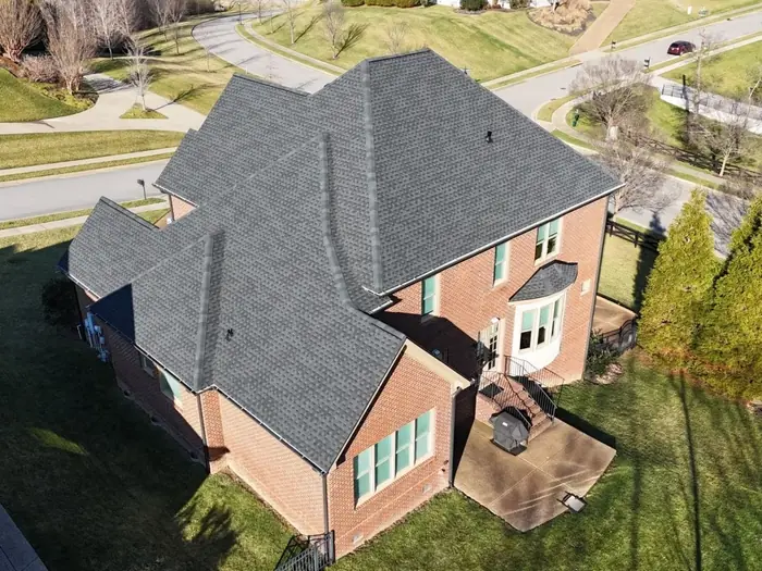 Brick two-story home with a finished roof replacement and new ridge vent
