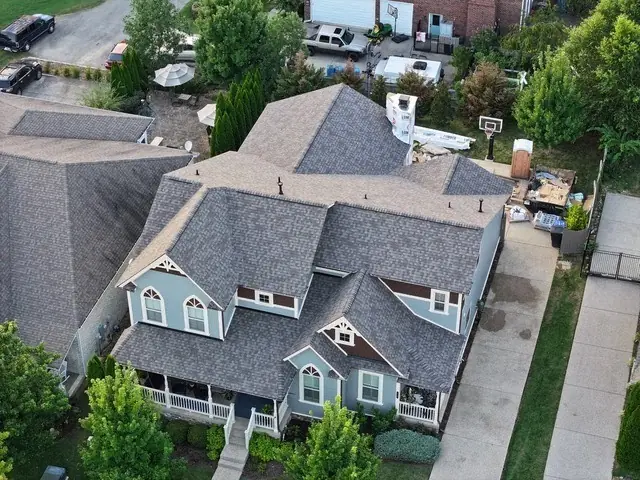Blue-sided home with new roofing and gutters in Mt. Juliet, TN