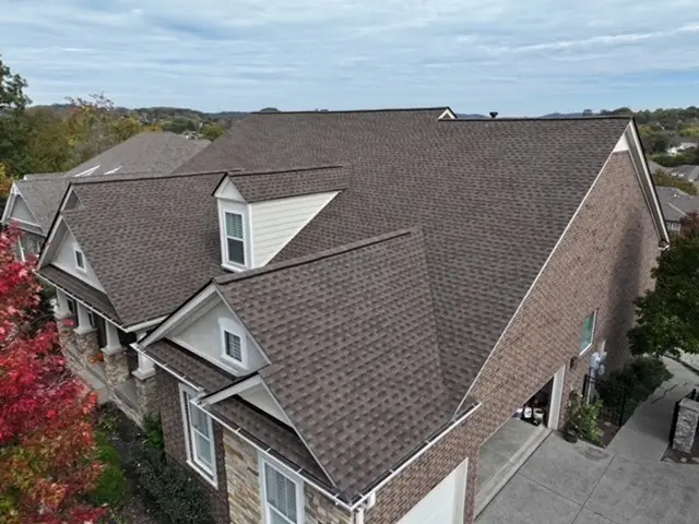Close aerial of a weathered-wood architectural shingle roof installation