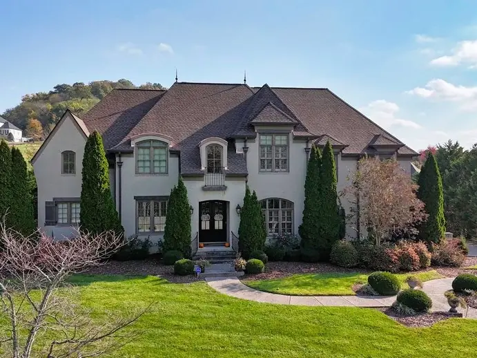 Brick estate with new roofing surrounded by fall color in Franklin, TN