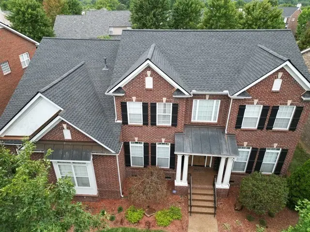 Red brick colonial with a completed roof replacement and new flashing