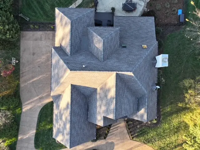 Overhead view of a hip roof replacement with new pipe boot flashings