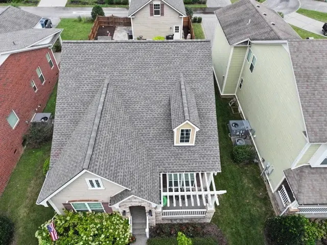 Brick home with a new roof, dormer and screened porch