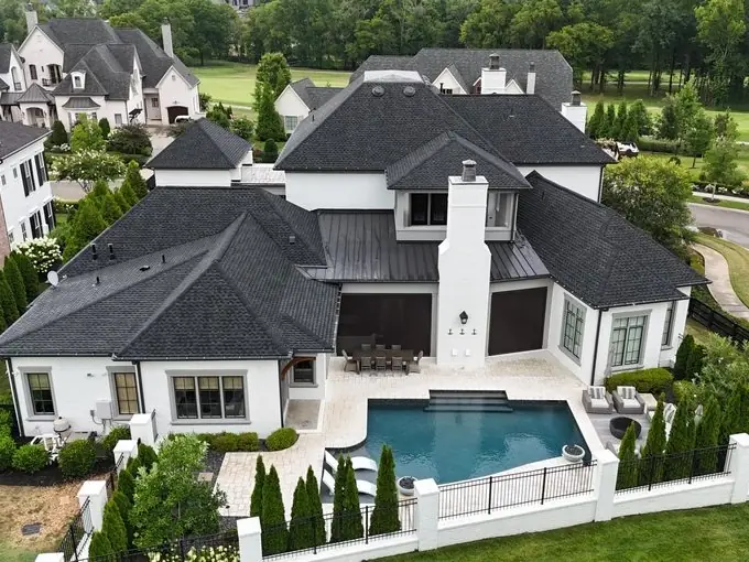 White modern farmhouse with a new dark shingle roof and pool, Franklin TN