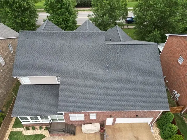 Overhead view of a large hip roof finished in dark architectural shingle