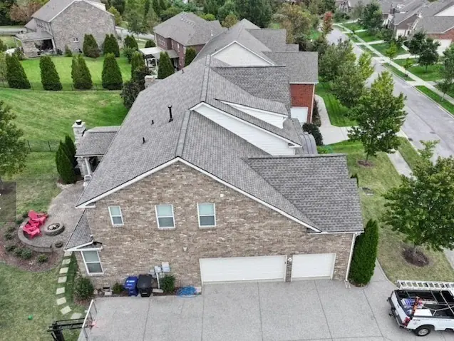 Stone and siding home with a new roof and three-car garage