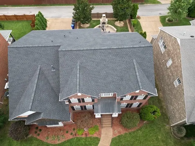 Overhead view of a large hip and gable roof replacement with new ridge vent