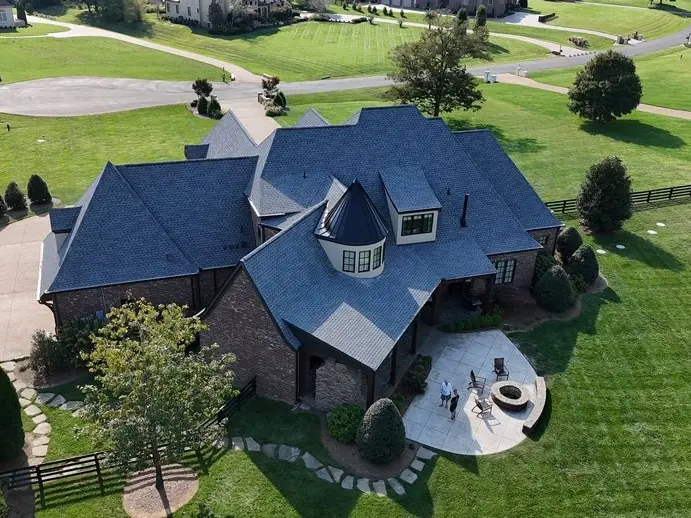 Brick estate with a dark slate-look roof and circular drive, Brentwood TN